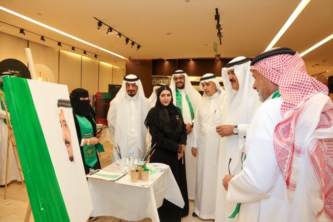 د. عبدالله الفوزان يطلع على رسم الفنان عادل اليحيى