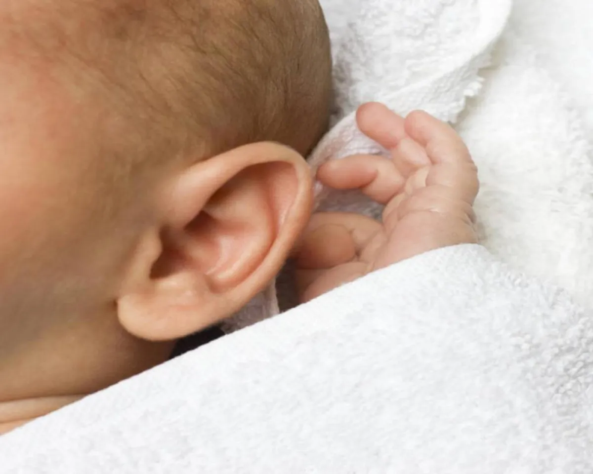     صورة لطفل يقوم بفرك أذنيه 