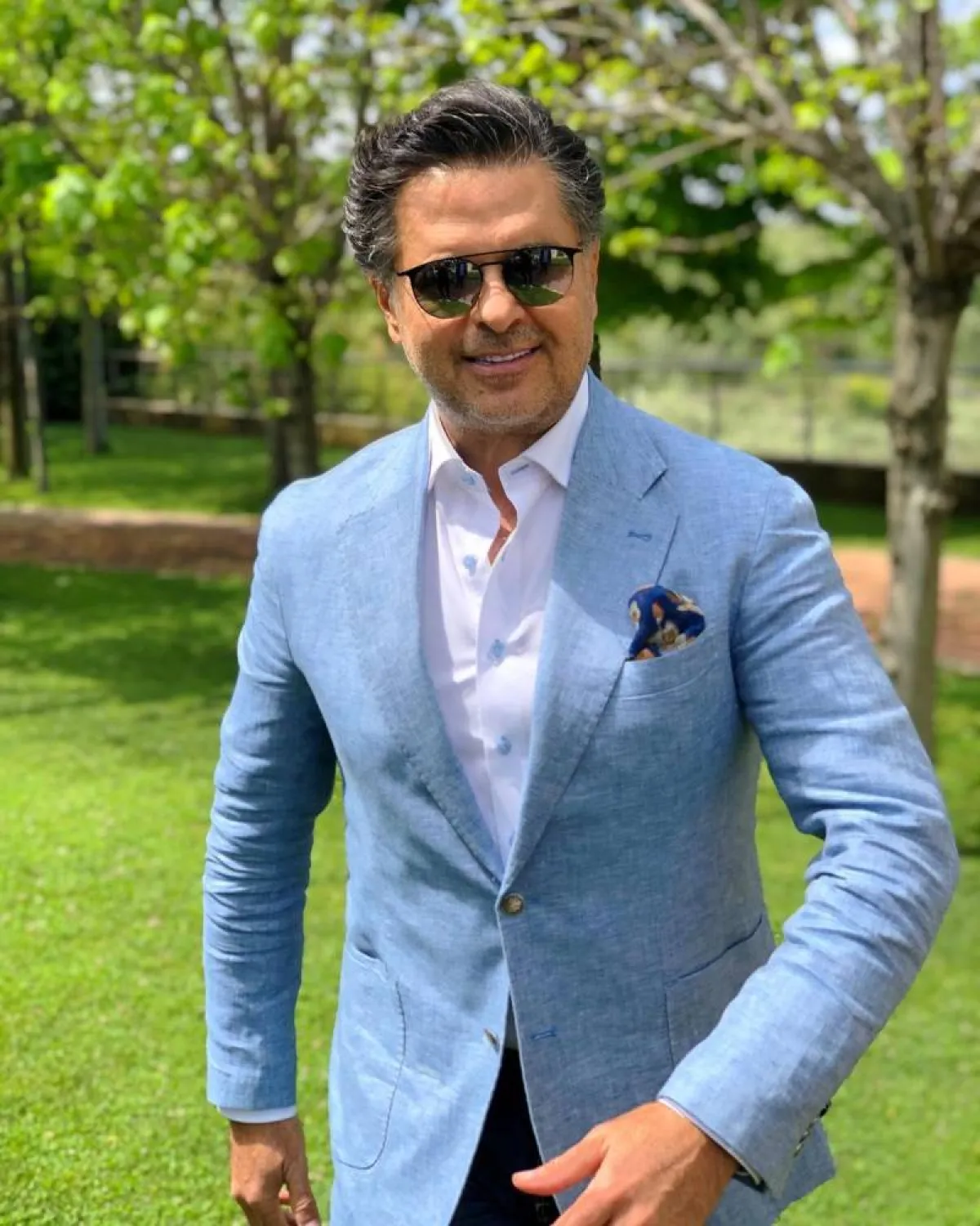 راغب علامة ببليزر أزرق باستيل مع قميص أبيض وبنطلون أسود