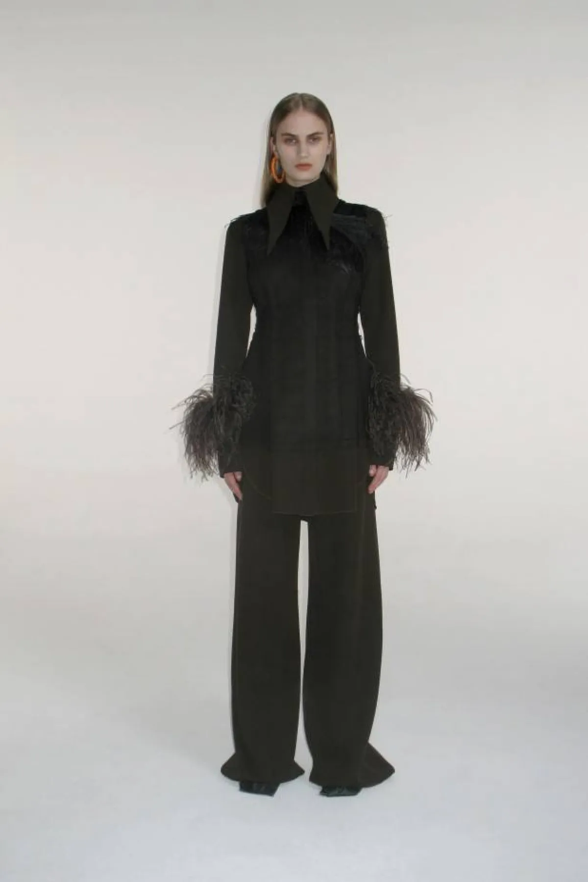 إطلالة سوداء بقميص من الكريب والمخمل والريش مع بنطلون واسع 