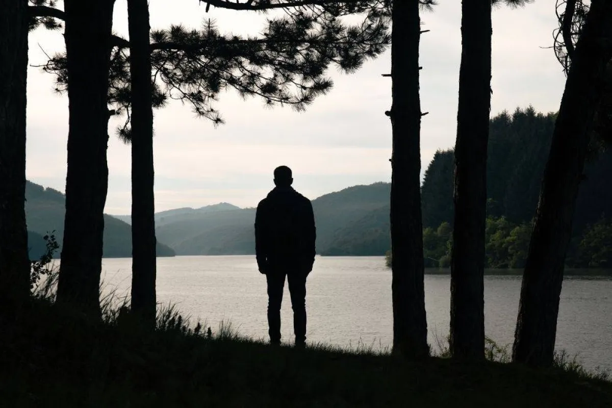 صورة تظهر رجل يتأمل البحيرة