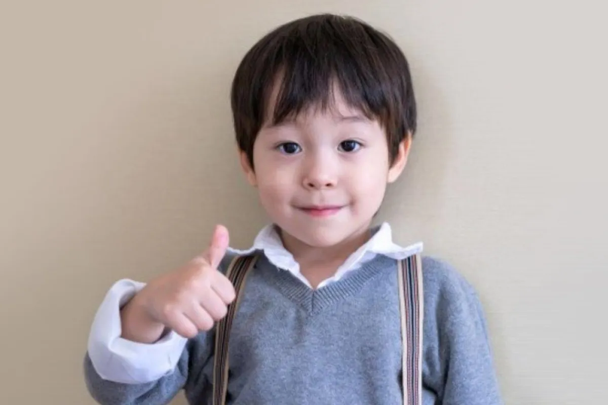 صورة لطفل يرفع علامة الإيجاب