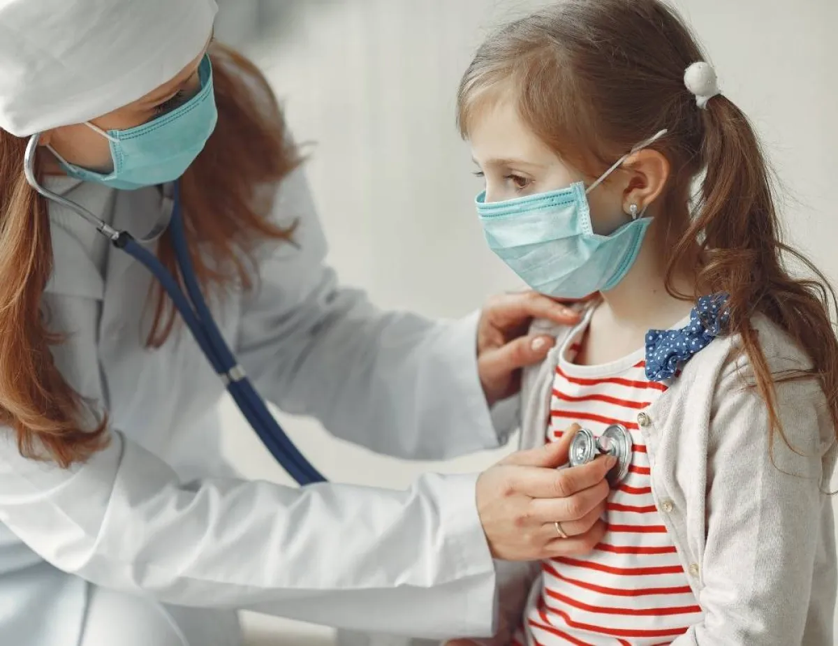 صورة لطبيبة تقيس معدل التنفس الصدري عند طفلة