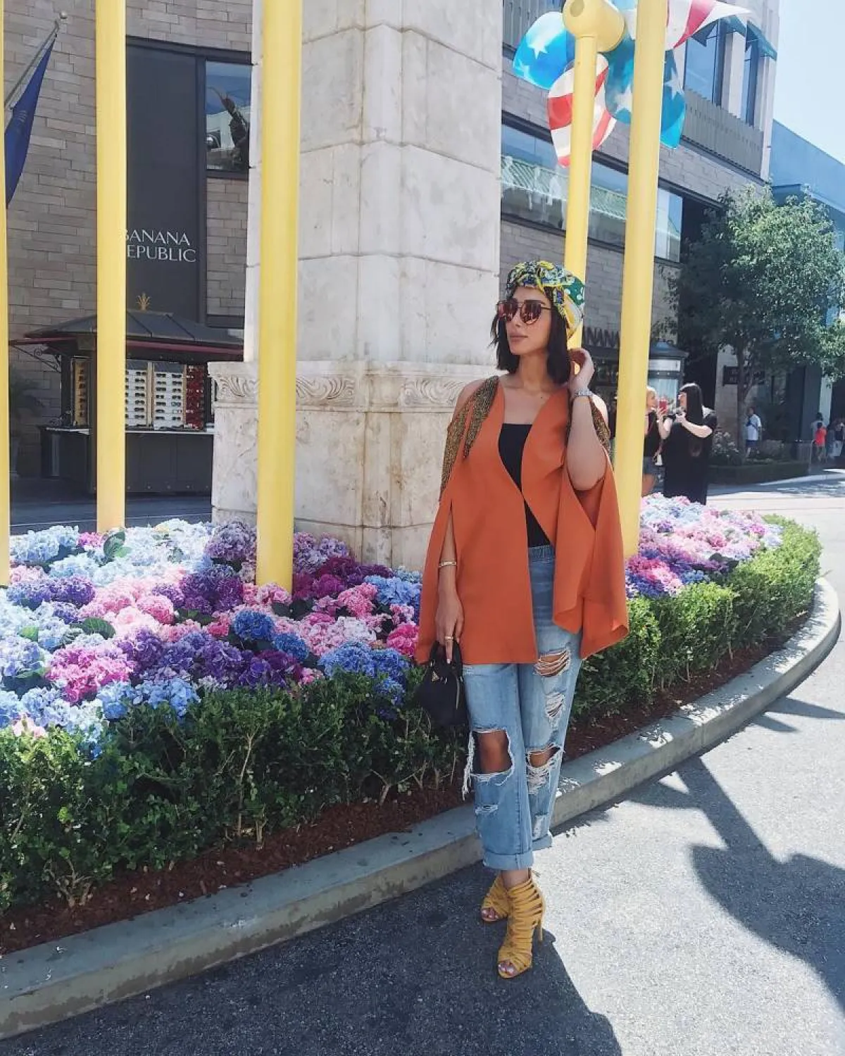 بسمة بوسيل ببنطلون جينز ممزق وصندل باللون الأصفر 