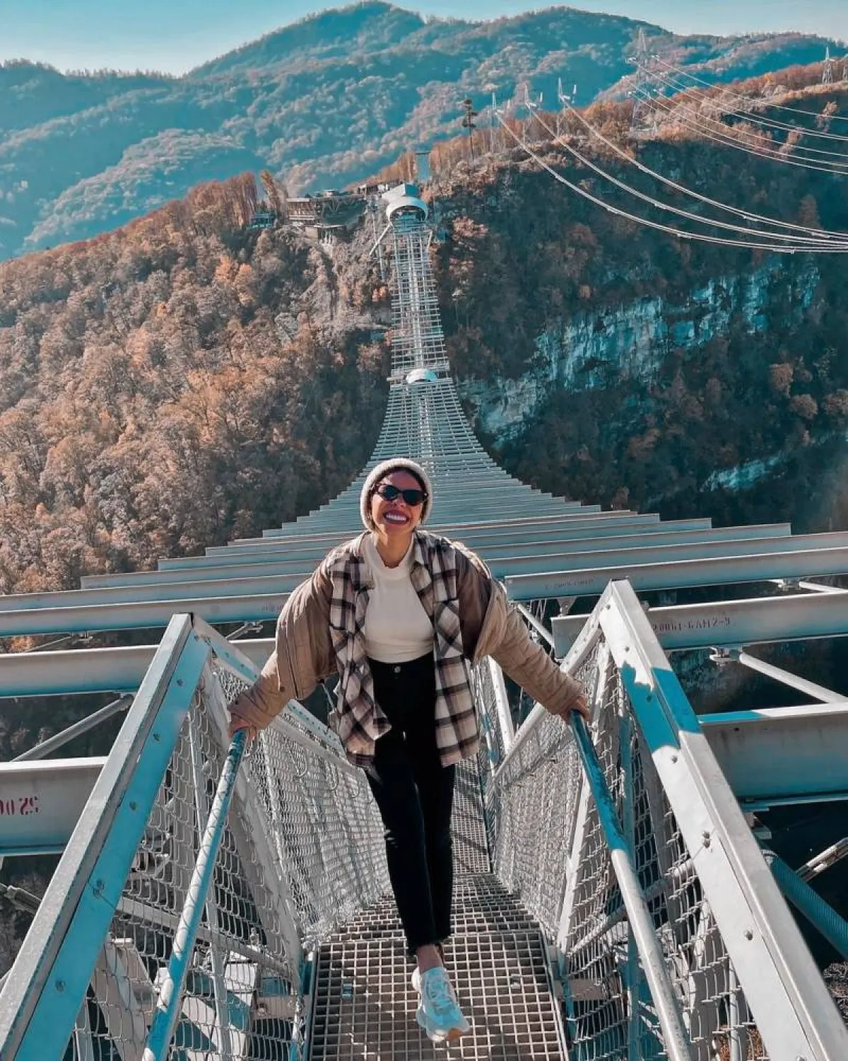 منة السني بجاكيت بيج وقميص كاروهات وبنطلون أسود