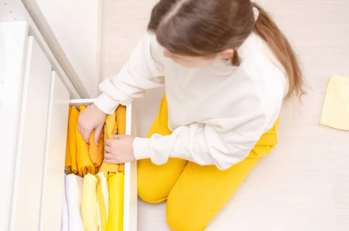 طفلة ترتب الملابس