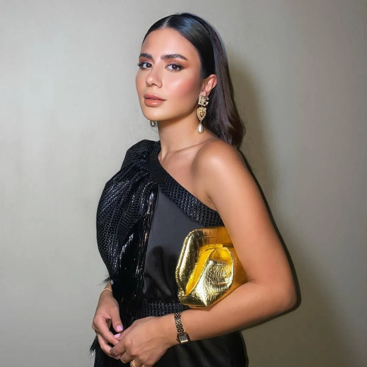 ديما الأسدي بحقيبة كلاتش ذهبية  