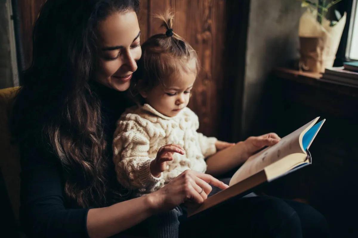 صورة لأم تقرأ لطفلتها