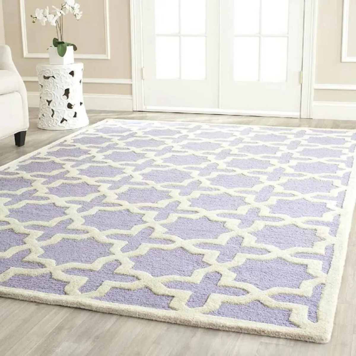 سجّادة منقوشة باللون الأبيض، على خلفيّة بلون اللافندر
