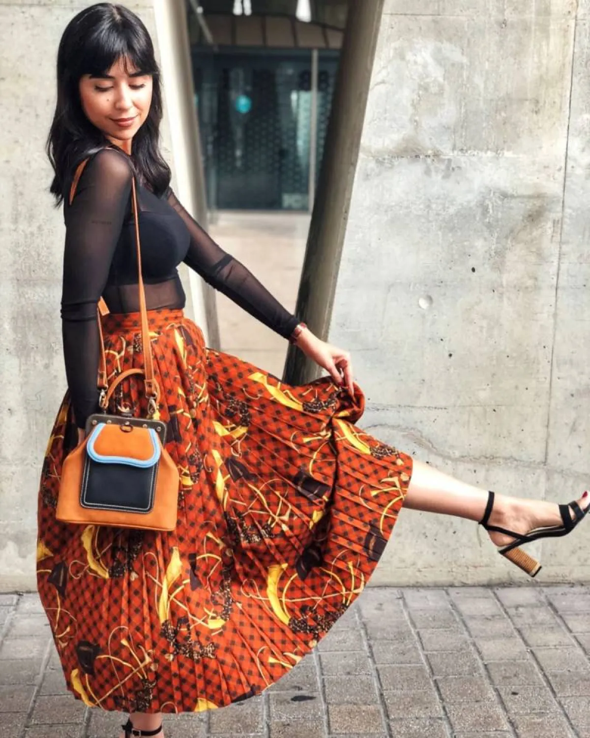 زينة مكي بتنورة بليسيه باللون البرتقالي 