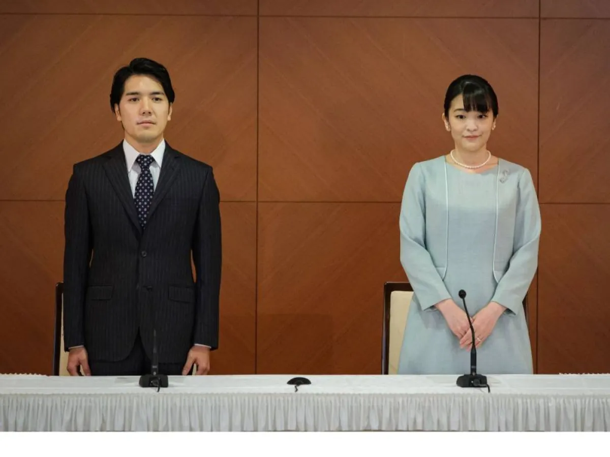apan's former princess Mako (R), the elder daughter of Prince Akishino and Princess Kiko, and her husband Kei Komuro (L), who she originally met while at university, pose at the start of a press conference to announce their marriage registration, at the Grand Arc Hotel in Tokyo on October 26, 2021. Nicolas Datiche / POOL / AFP