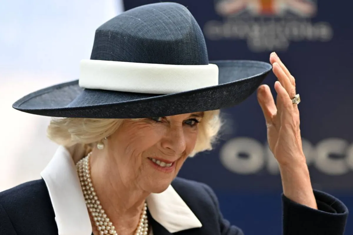 Britain's Camilla, Queen Consort holds on to her hat in the winner's enclosure on Qipco British Champions Day at Ascot Racecourse, west of London on October 15, 2022. Champions day is the finale of the British flat racing season and the UK's richest raceday. Glyn KIRK / AFP
