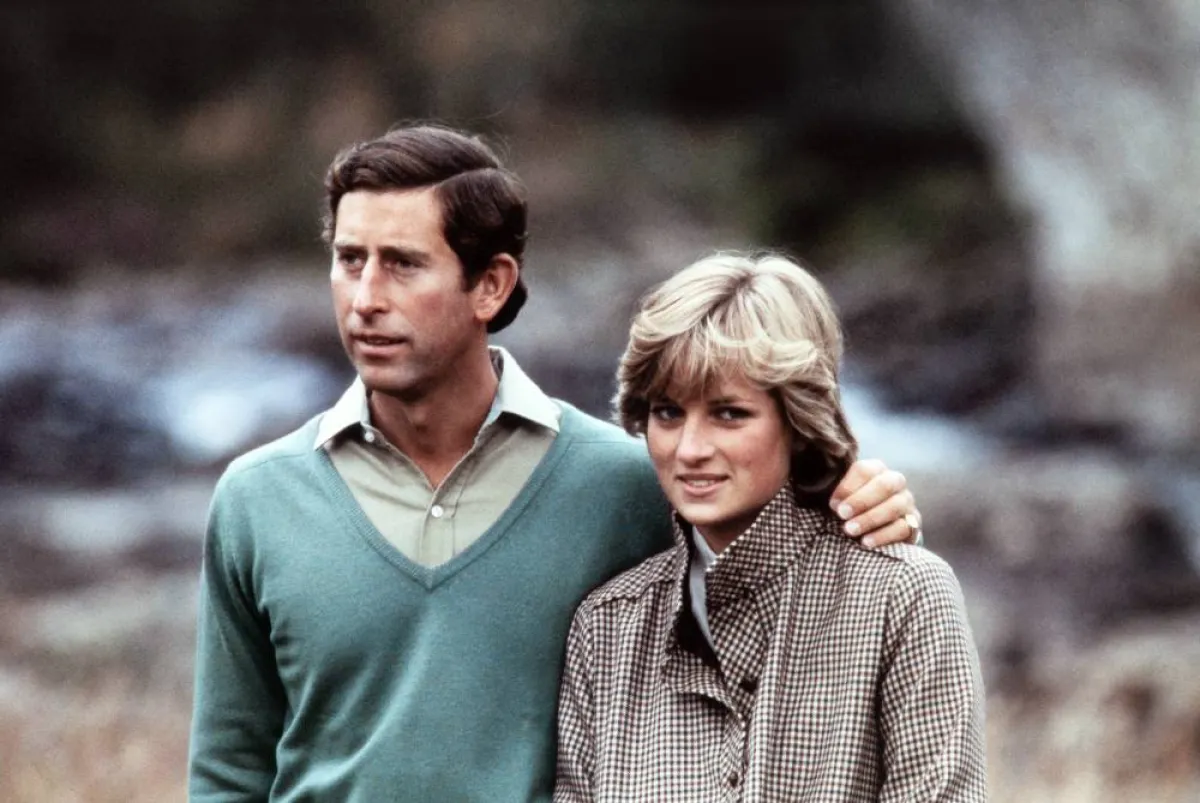 Prince Charles, Prince of Wales, wearing a kilt, and Diana, Princess of Wales, pose for photographers beside the River Dee in Scotland during their post-honeymoon visit to the Royal Residence at Balmoral Castle, on August 19, 1981. POOL / AFP