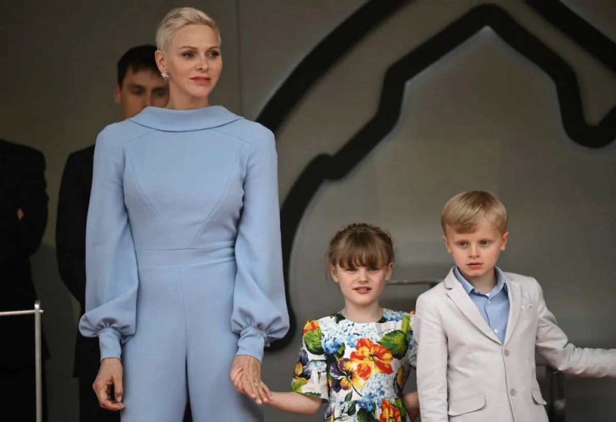 Princess Charlene (L) of Monaco stands with her children Jacques and Gabriella on the podium after the Monaco Formula 1 Grand Prix at the Monaco street circuit in Monaco, on May 29, 2022. LOIC VENANCE / AFP