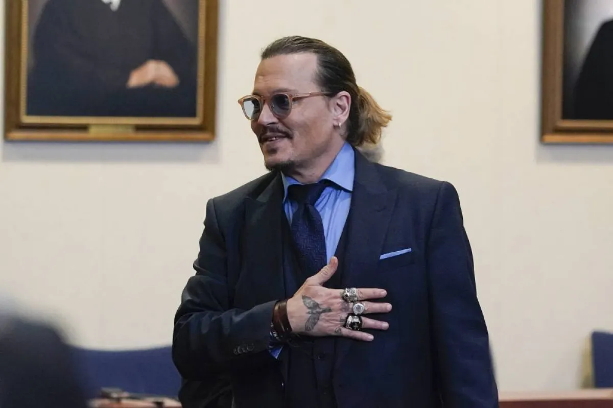 Actor Johnny Depp gestures to spectators in court after closing arguments at the Fairfax County Circuit Courthouse in Fairfax, Virginia, on May 27, 2022. Actor Johnny Depp is suing ex-wife Amber Heard for libel after she wrote an op-ed piece in The Washington Post in 2018 referring to herself as a “public figure representing domestic abuse.” Steve Helber / POOL / AFP