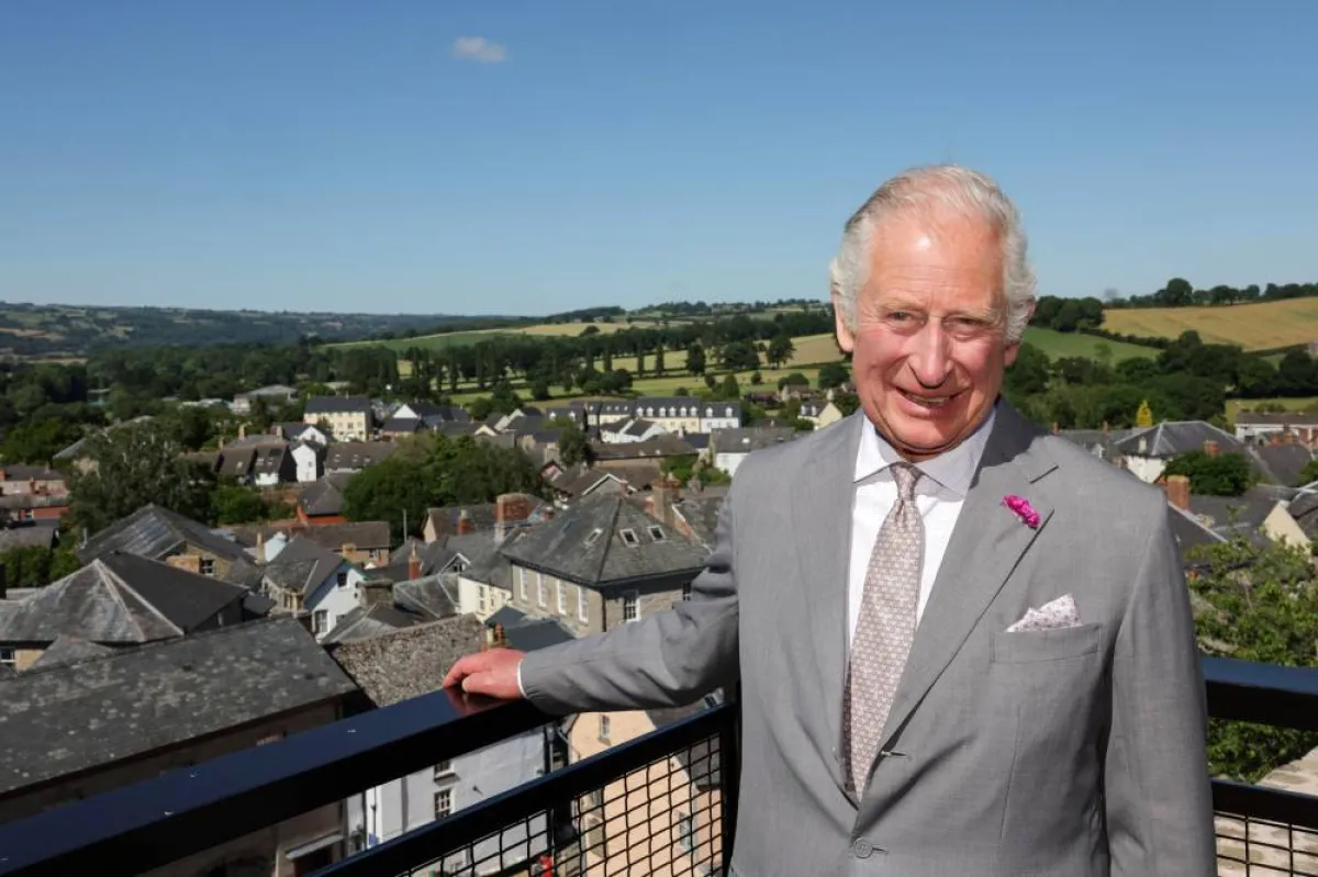 Britain's Prince Charles, Prince of Wales poses for a photograph at the viewing platform during a visit to Hay Castle, in Hay-on-Wye, Wales, on July 7, 2022. This summer, Hay Castle opens its doors to the public for the first time in its 900-year history, following a major restoration project creating an important new heritage destination, a vibrant new centre for learning and the arts, and a space for the community to come together.Chris Jackson / POOL / AFP