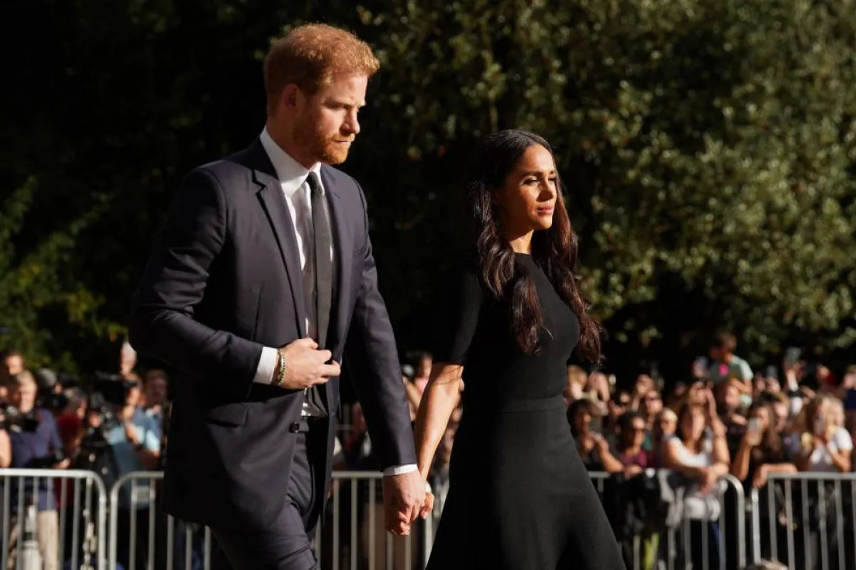 Britain's Prince Harry, Duke of Sussex (L) and Meghan, Duchess of Sussex (R) arrive to look at floral tributes on the Long walk at Windsor Castle on September 10, 2022, two days after the death of Britain's Queen Elizabeth II at the age of 96. King Charles III pledged to follow his mother's example of "lifelong service" in his inaugural address to Britain and the Commonwealth on Friday, after ascending to the throne following the death of Queen Elizabeth II on September 8. Kirsty O'Connor / POOL / AFP