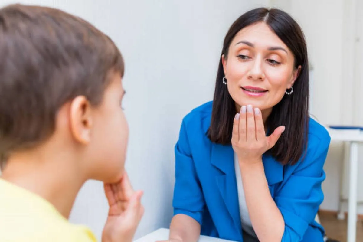 صورة لأخصائية تدرب الطفل على النطق