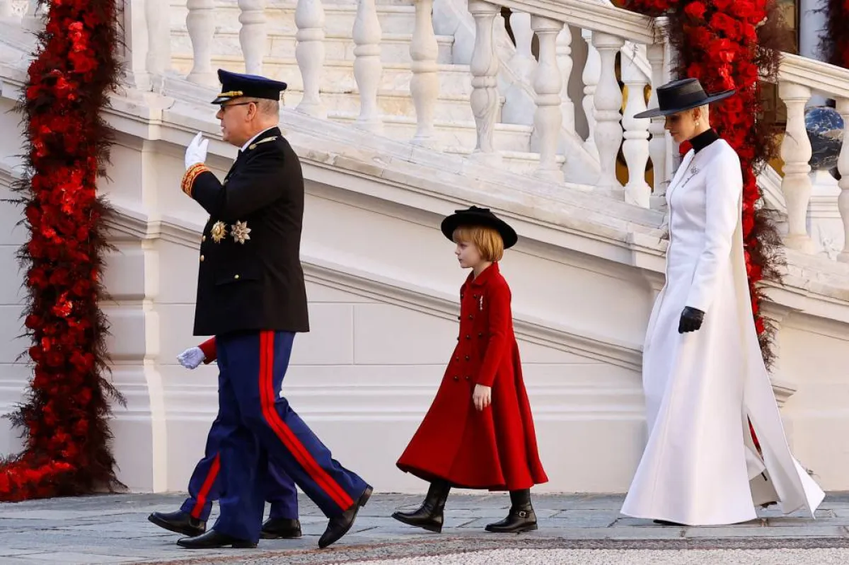 Prince Albert II of Monaco (L), Princess Gabriella and Princess Charlene of Monaco attend celebrations as part of ceremonies marking the National Day at the Palace in Monaco on November 19, 2022. ERIC GAILLARD / POOL / AFP