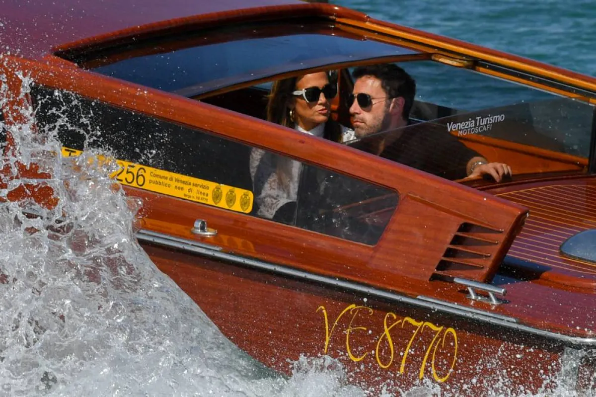 US actor Ben Affleck and US actress and singer Jennifer Lopez travel aboard a vaporetto taxi boat on September 9, 2021 after they arrived to attend the 78th Venice Film Festival in Venice. Filippo MONTEFORTE / AFP