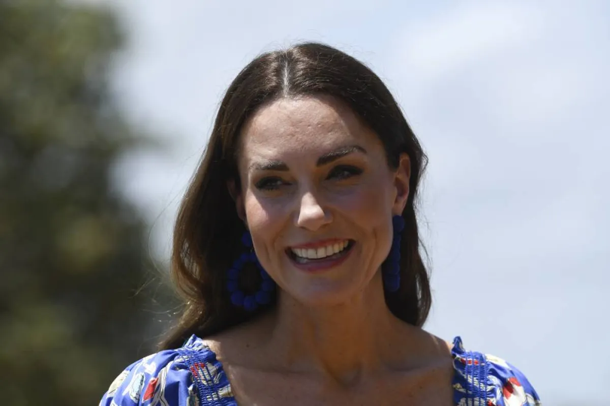 Britain's Catherine, Duchess of Cambridge, smiles upon her arrival with Britain's Prince William, Duke of Cambridge (out of frame), at Hopkins Village, Belize on March 20, 2022. Johan ORDONEZ / AFP