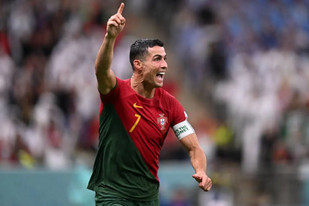 Portugal's forward #07 Cristiano Ronaldo celebrates scoring his team's first goal during the Qatar 2022 World Cup Group H football match between Portugal and Uruguay at the Lusail Stadium in Lusail, north of Doha on November 28, 2022. FIFA later attributed the goal to Portugal's midfielder #08 Bruno Fernandes. Kirill KUDRYAVTSEV / AFP