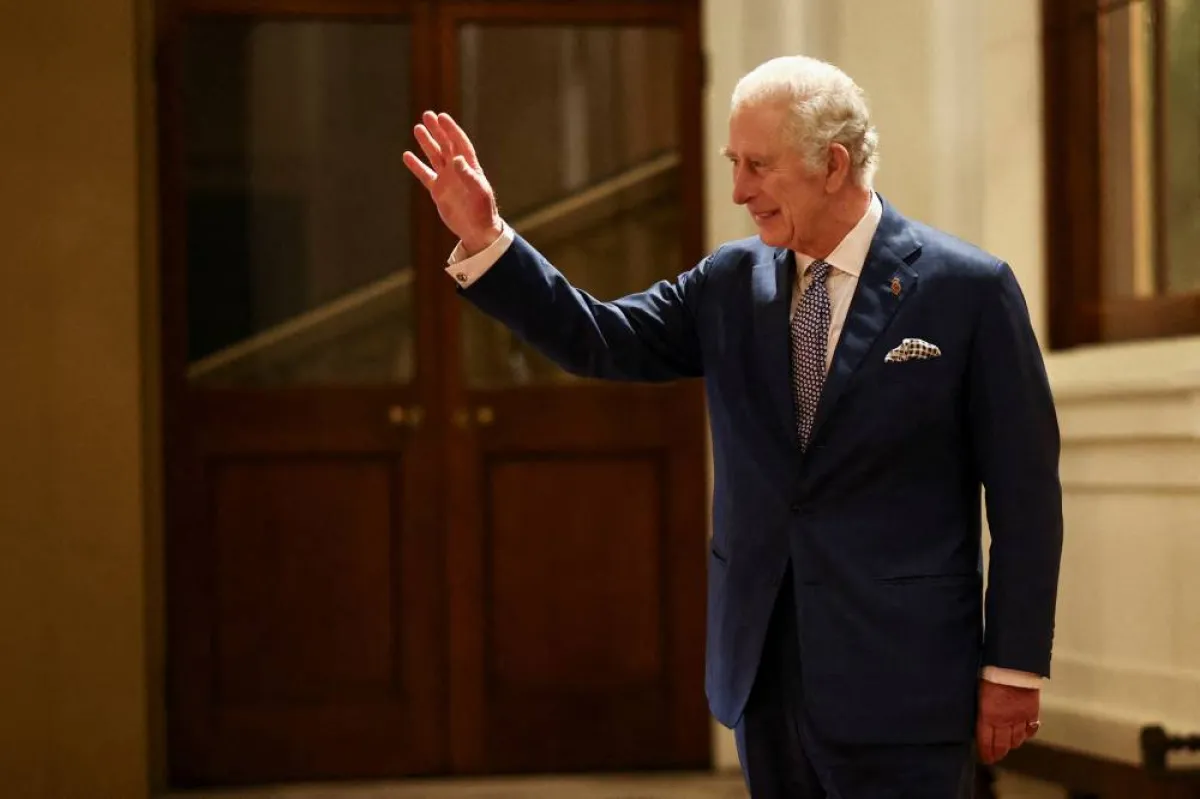 Britain's King Charles III waves as South Africa's President Cyril Ramaphosa (unseen) is driven away following a formal farewell at Buckingham Palace in London on November 23, 2022 at the end of the President's two-day state visit. Ramaphosa urged rich nations to help save vulnerable ones from climate change, as he made the first state visit of King Charles III's reign. HENRY NICHOLLS / POOL / AFP