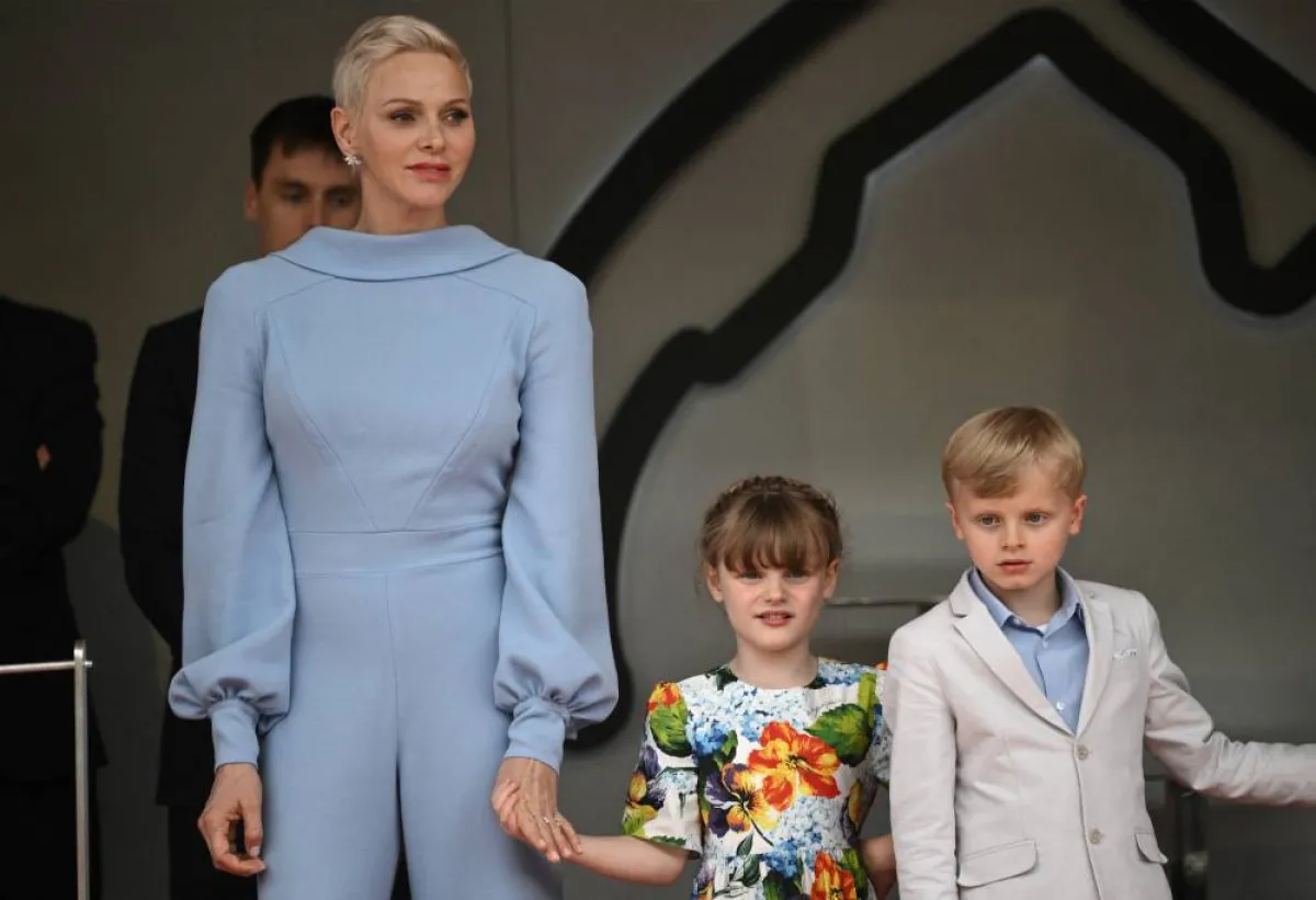 Princess Charlene (L) of Monaco stands with her children Jacques and Gabriella at the Monaco street circuit in Monaco, on May 29, 2022. LOIC VENANCE / AFP