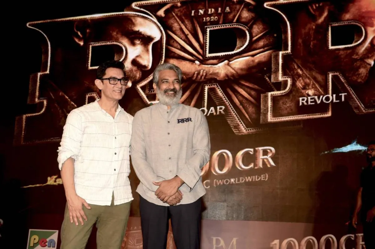 In this picture taken on April 6, 2022, Bollywood actor Aamir Khan (L) attends an event to celebrate the box office success of the Telugu-language period action drama film 'RRR' directed by S. S. Rajamouli (R) in Mumbai. SUJIT JAISWAL / AFP