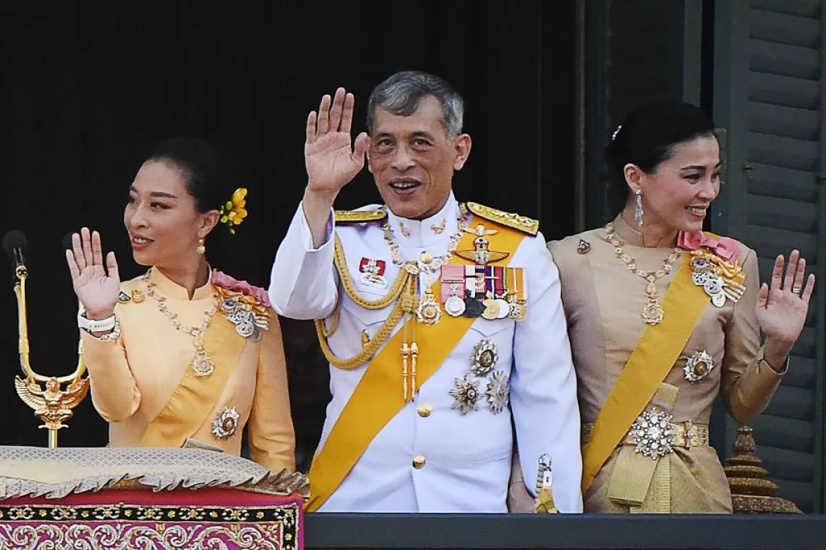 In this file photo taken on May 6, 2019, Thailand's King Maha Vajiralongkorn (C), Queen Suthida and his daughter Princess Bajrakitiyabha Mahidol (L) wave to well-wishers from the balcony of Suddhaisavarya Prasad Hall of the Grand Palace as they grant a public audience on the final day of his royal coronation in Bangkok.  Jewel SAMAD / AFP