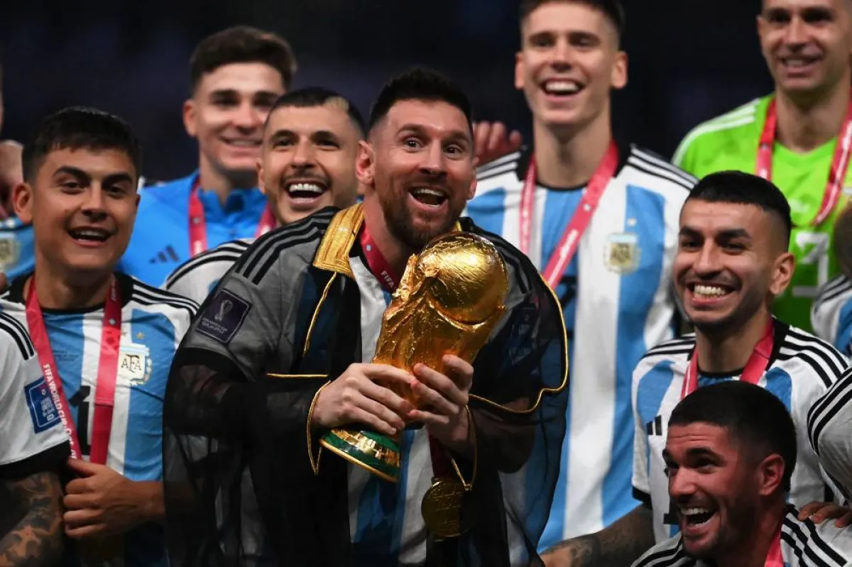 Argentina's forward #10 Lionel Messi lifts the World Cup trophy at Lusail Stadium in Lusail, north of Doha on December 18, 2022. Argentina won in the penalty shoot-out. FRANCK FIFE / AFP