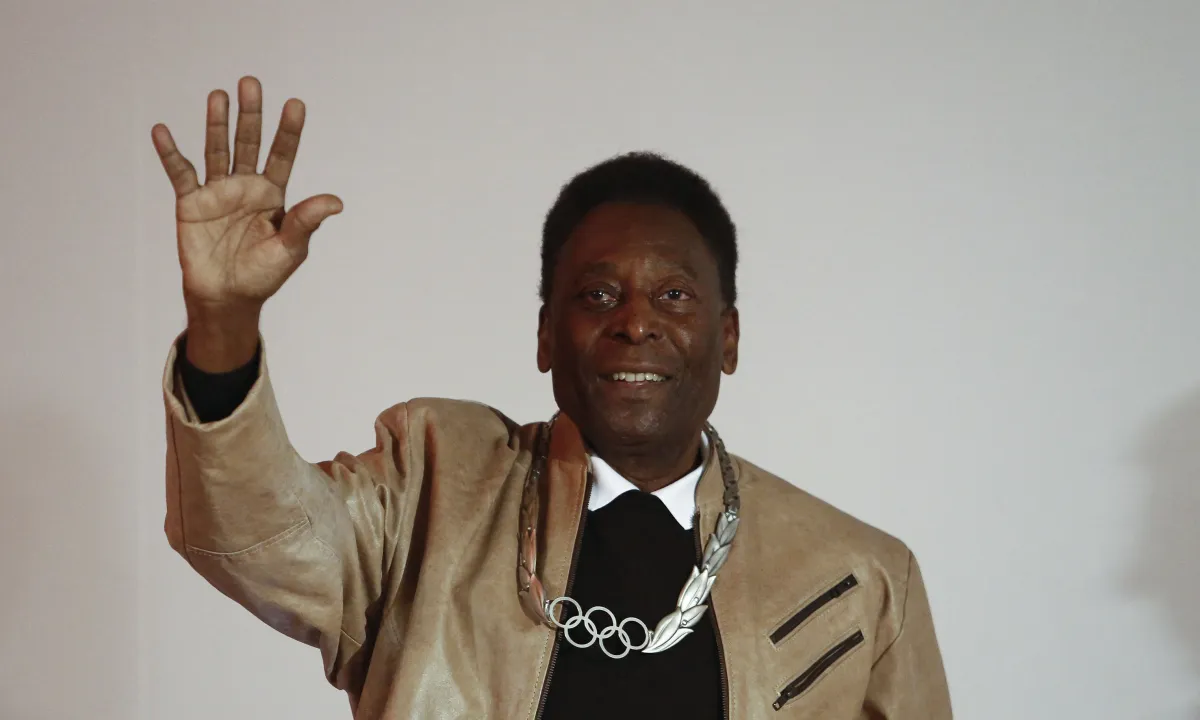 FILES) In this file photo taken on June 16, 2016, Brazilian retired footballer Edson Arantes do Nascimento, know as Pele, waves after being decorated with an Olympic Order Medal at the Pele Museum in Santos, Sao Paulo, Brazil. Football legend Pele gave Brazil a virtual pre-match pep talk Thursday November 24, 2022, as the national team prepared to make their World Cup debut, telling them: "Bring this trophy home." Miguel Schincariol / AFP