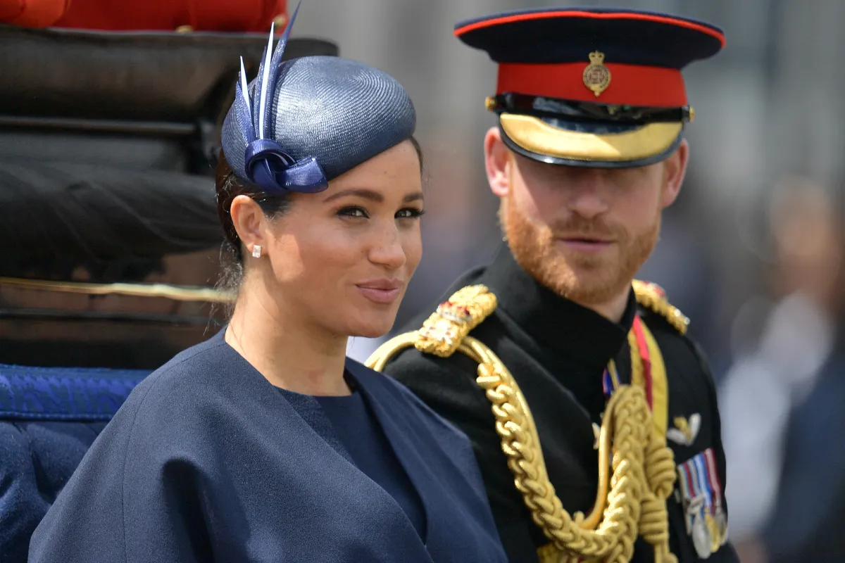 Britain's Meghan, Duchess of Sussex (L) and Britain's Prince Harry, Duke of Sussex (R) return to Buckingham Palace after the Queen's Birthday Parade, 'Trooping the Colour', in London on June 8, 2019. The ceremony of Trooping the Colour is believed to have first been performed during the reign of King Charles II. Since 1748, the Trooping of the Colour has marked the official birthday of the British Sovereign. Over 1400 parading soldiers, almost 300 horses and 400 musicians take part in the event. Daniel LEAL