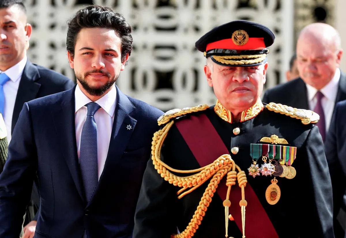 Jordan's King Abdullah II (R), accompanied by Crown Prince Hussein bin Abdullah II (L), reviews the honour guard upon his arrival at parliament, as he opens the regular session in the capital Amman on November 12, 2017. KHALIL MAZRAAWI / AFP