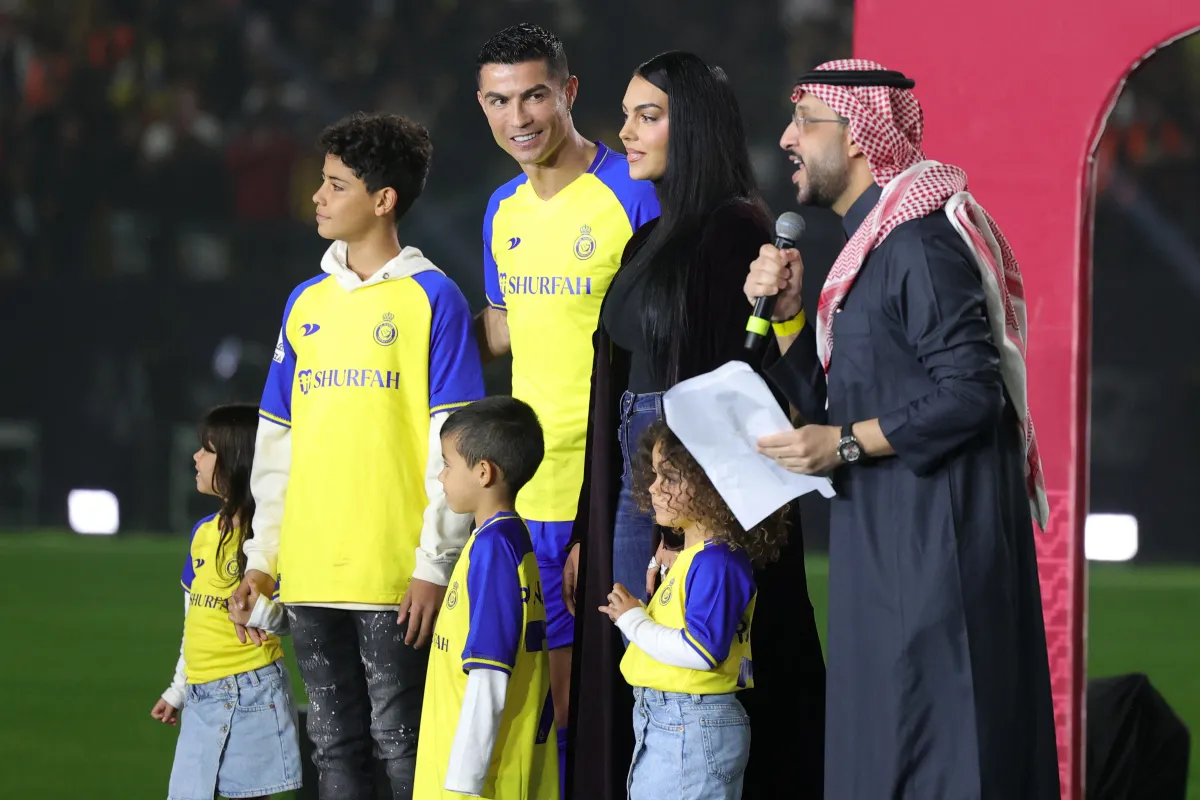 Al-Nassr's new Portuguese forward Cristiano Ronaldo (C-L), his partner Georgina Rodriguez (C-R) and his children stand on the stage during his unveiling at the Mrsool Park Stadium in the Saudi capital Riyadh on January 3, 2023. Fayez Nureldine / AFP