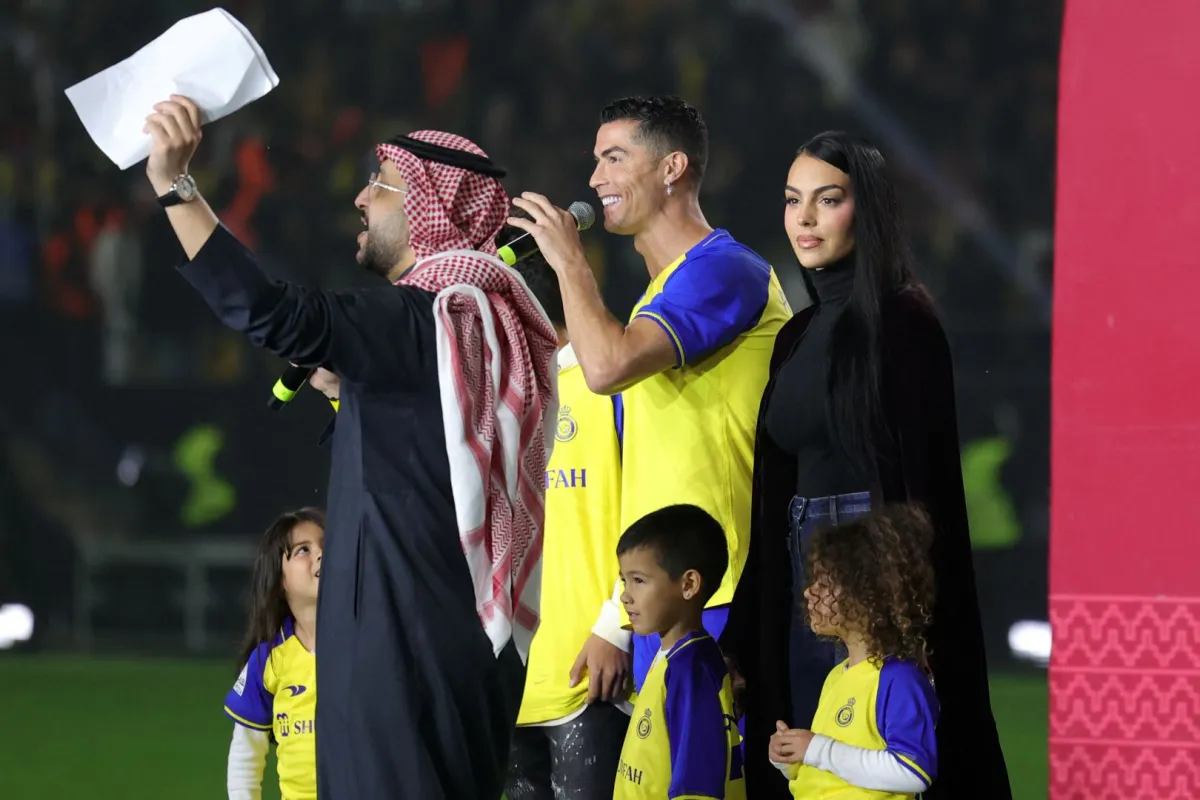 Al-Nassr's new Portuguese forward Cristiano Ronaldo (C), his partner Georgina Rodriguez (2nd-L) and his children stand on the stage during his unveiling at the Mrsool Park Stadium in the Saudi capital Riyadh on January 3, 2023. Fayez Nureldine / AFP