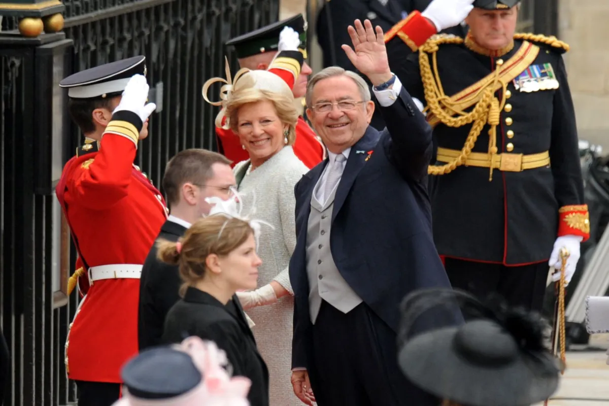 Former King Constantine of Greece waves as he arrives with his wife Anna-Marie at the West Door of Westminster Abbey in London for the wedding of Britain's Prince William and Kate Middleton, on April 29, 2011. AFP PHOTO / BEN STANSALL