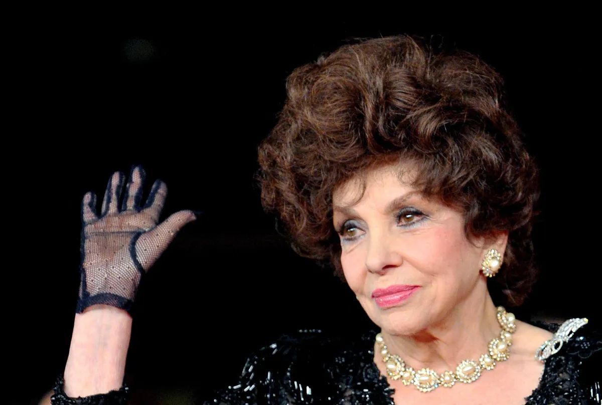 In this file photo taken on November 16, 2012, Italian actress Gina Lollobrigida waves upon her arrival for the premiere of the documentary film "Enzo Mirigliani" during the 7th Rome film festival. Tiziana FABI / AFP