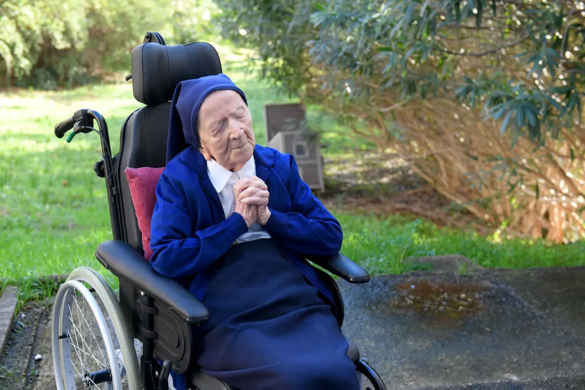 Sister Andre, Lucile Randon in the registry of birth, the eldest French and European citizen, prays in a wheelchair, on the eve of her 117th birthday, in an EHPAD in Toulon, southern France on February 10, 2021. NICOLAS TUCAT / AFP