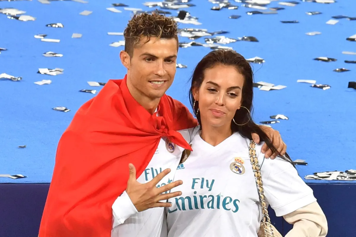 Real Madrid's Portuguese forward Cristiano Ronaldo poses with his girlfriend Georgina Rodriguez after his team won the UEFA Champions League final football match between Liverpool and Real Madrid at the Olympic Stadium in Kiev, Ukraine on May 26, 2018. Sergei SUPINSKY / AFP