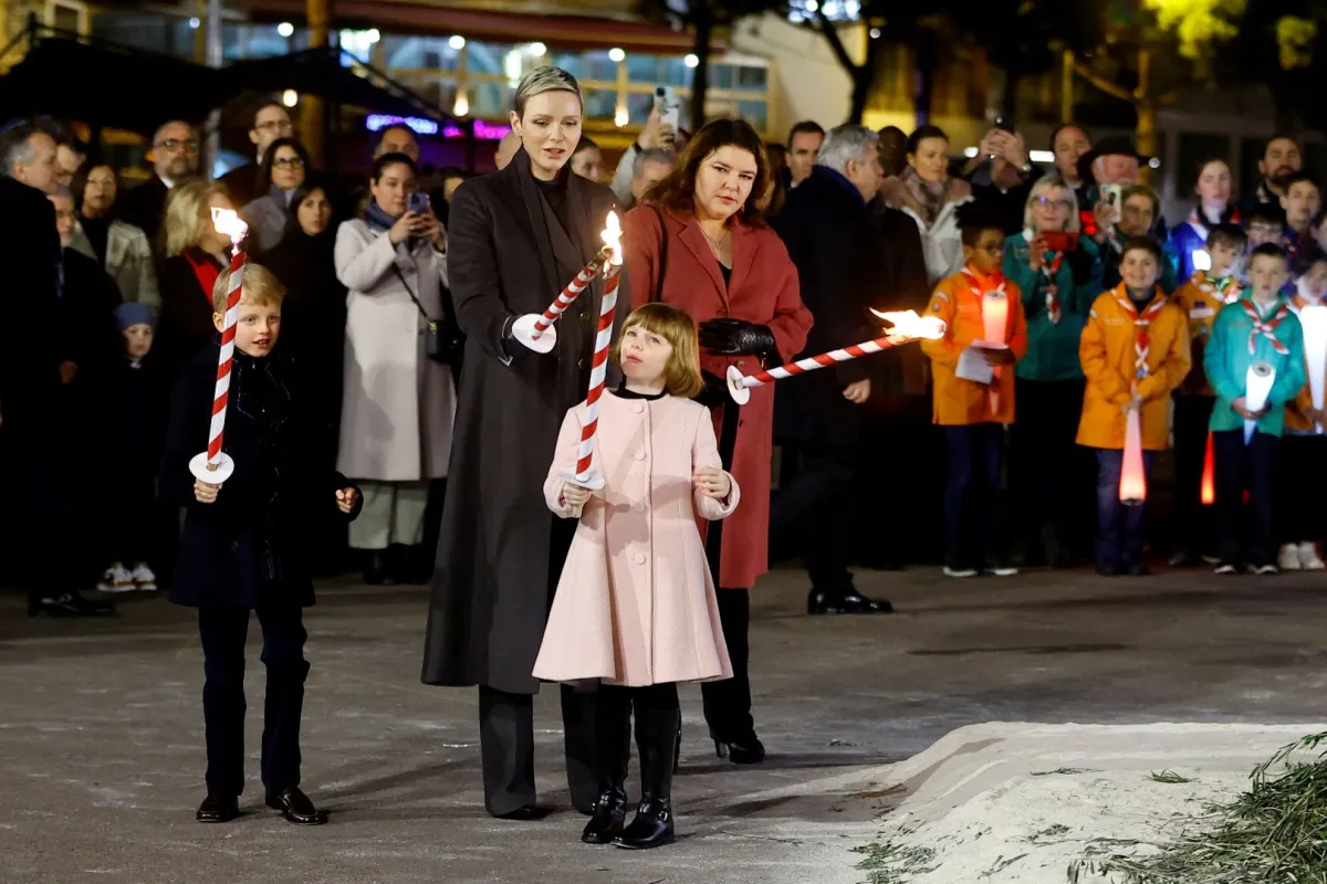 Monaco's Princess Charlene and her children Prince Jacques and Princess Gabriella, flanked by Melanie-Antoinette de Massy (R), set alight a sailboat during the traditional festivities of Sainte Devote in the Principality of Monaco, on January 26, 2023. ERIC GAILLARD / POOL / AFP
