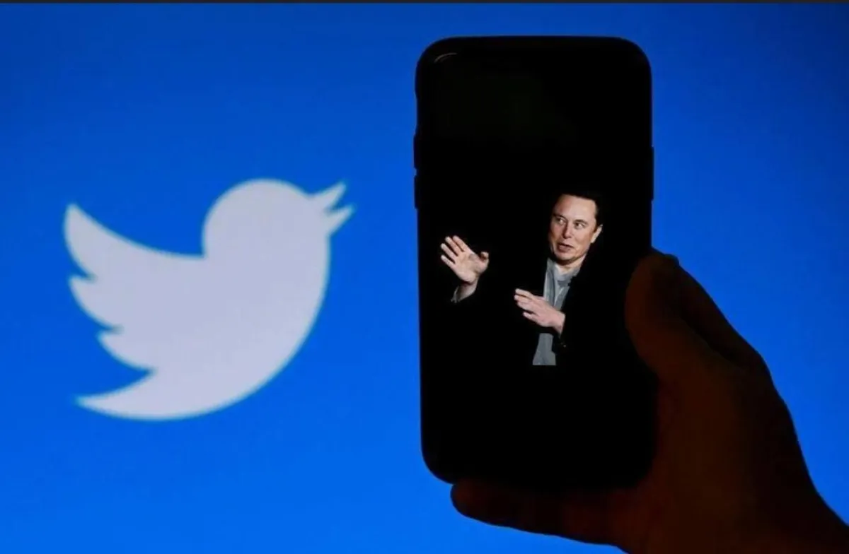 a photo of Elon Musk with the Twitter logo shown in the background, on October 4, 2022, in Washington, OLIVIER DOULIERY / AFP