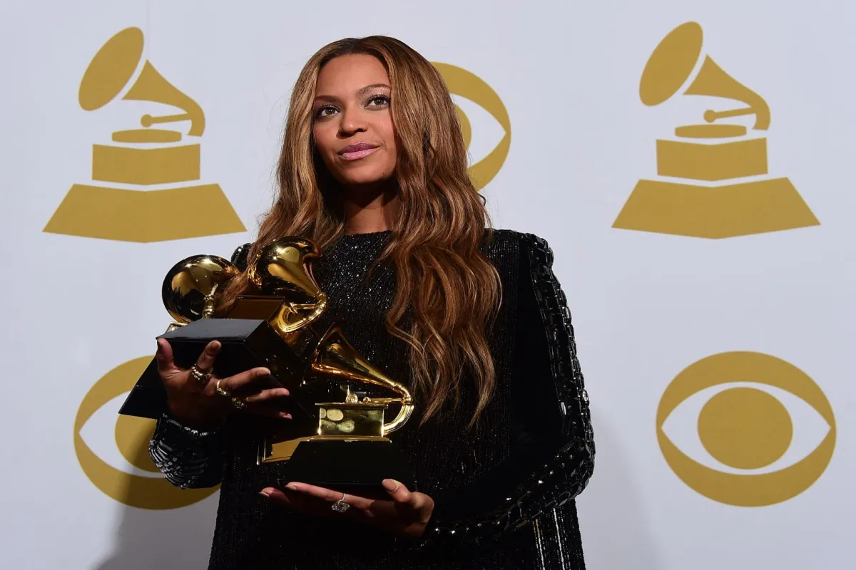 Beyonce poses with her three Grammys in the press room during the 57th annual Grammy Awards in Los Angeles, California on February 8, 2015. AFP PHOTO / FREDERIC J. BROWN