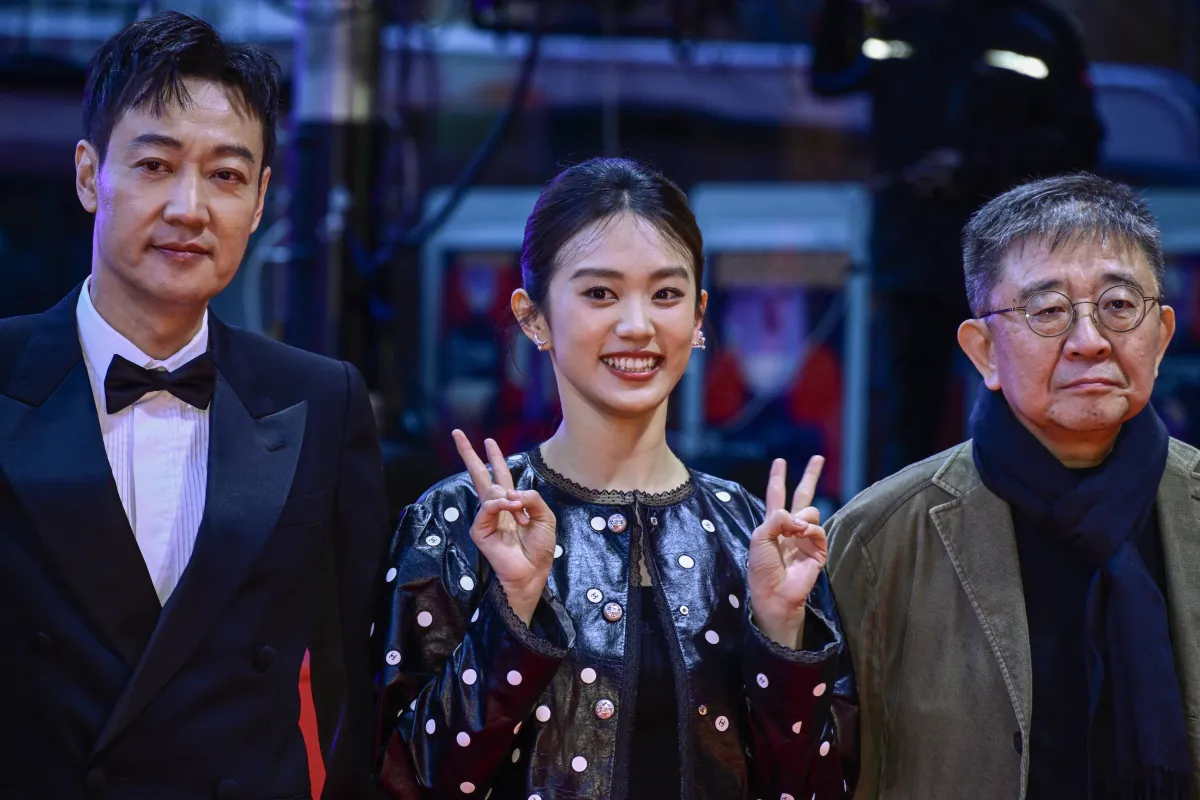 (L to R) Chinese actor Xin Baiqing, actress Huang Yao and director Zhang Lu pose on the red carpet for the film "The Shadowless Tower" in competition at the Berlinale, Europe's first major film festival of the year, on February 18, 2023 in Berlin. John MACDOUGALL / AFP