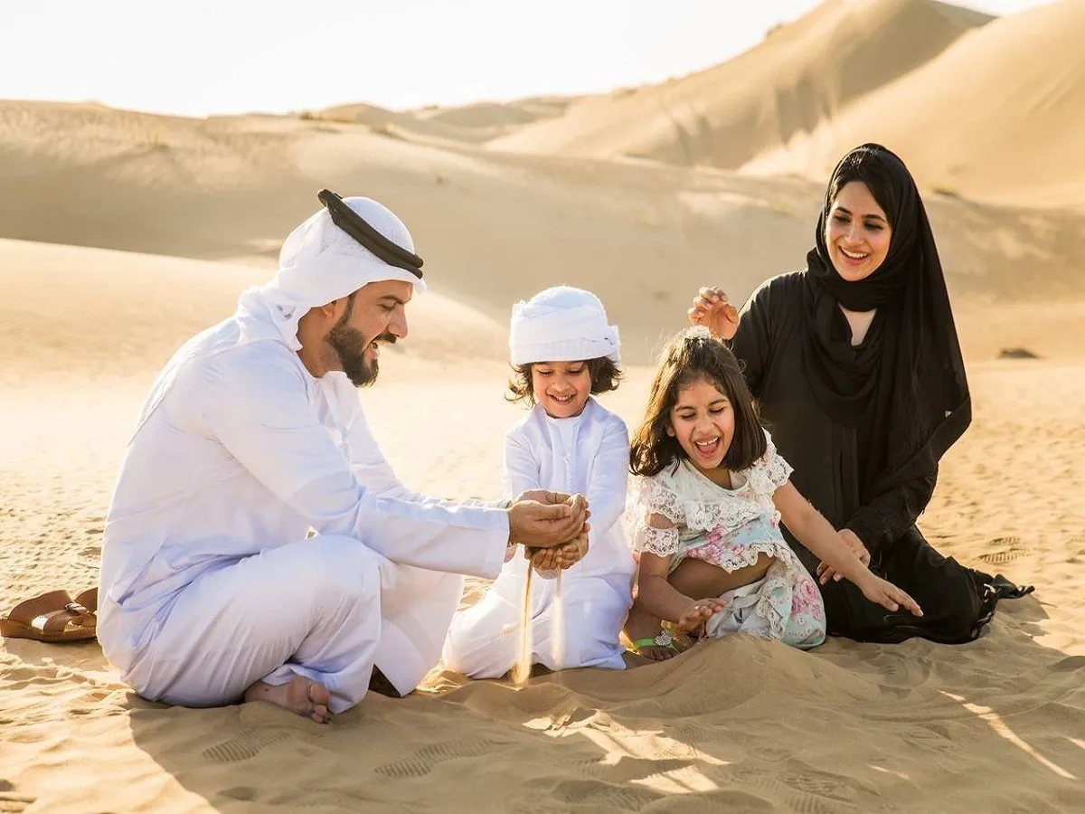 صورة لعائلة تجلس بالصحراء