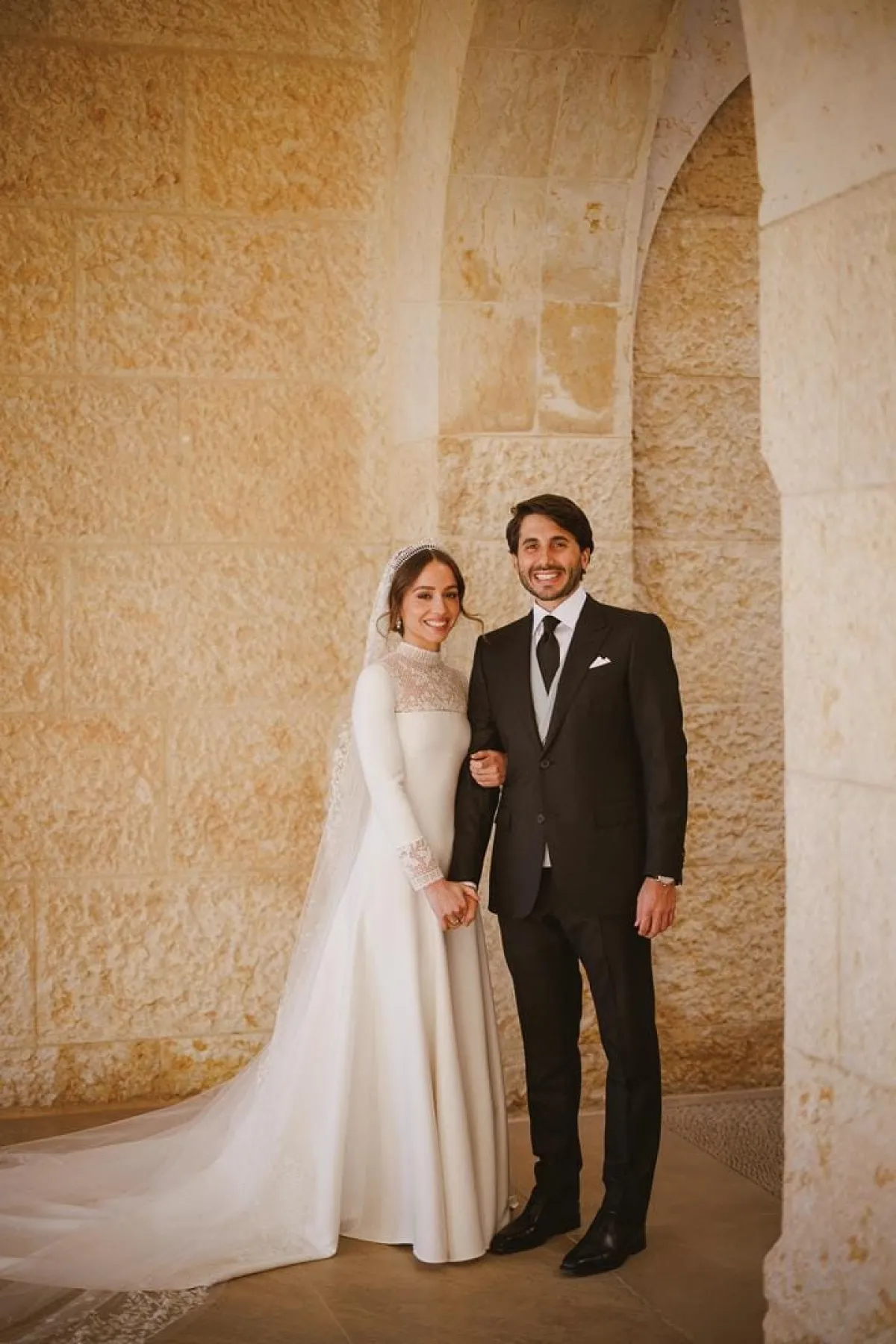 A handout picture released by Jordan's Royal Palace shows the bride and groom posing for photographrs during the wedding ceremony of the Jordanian monarch's eldest daughter Princess Iman and Jameel Alexander Thermiotis in Amman on March 12, 2023. Thermiotis, who was born in 1994 in Venezuela to a family of Greek origin, currently works in the field of finance in New York. AFP PHOTO / JORDANIAN ROYAL PALACE