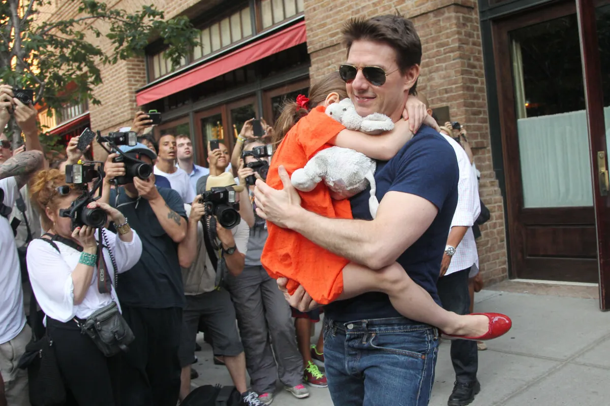 Tom Cruise leaves his hotel carrying daughter Suri for her gymnastics class on July 17, 2012 in New York, NY.  MEHDI TAAMALLAH / AFP