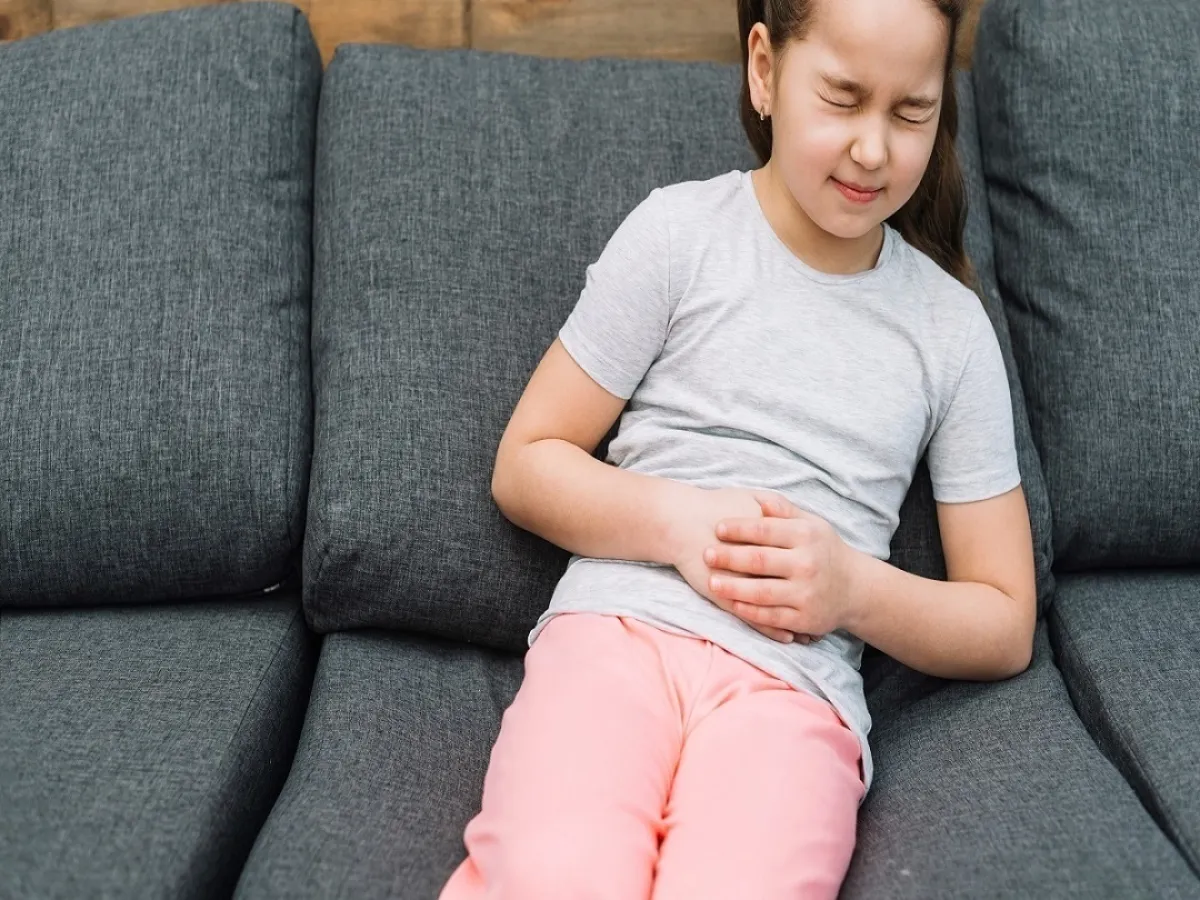 صورة لطفلة تعاني من ألم بمعدتها