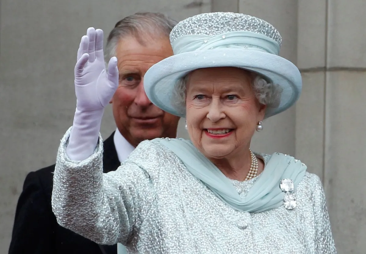  Queen Elizabeth II waves from the balcony of Buckingham Palace as Prince Charles, Prince of Wales looks on, during the finale of the Queen's Diamond Jubilee celebrations on June 5, 2012 in London, England.(Photo by Stefan Wermuth - WPA Pool/Getty Images)