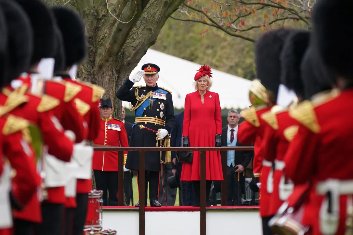 King Charles III (centre left) and Britain's Camilla, Queen Consort (centre right) attend a ceremony to present the new standards and colours to the Royal Navy, the Life Guards of the Household Cavalry Mounted Regiment, The King’s Company of the Grenadier Guards and The King’s Colour Squadron of the Royal Air Force at Buckingham Palace, in London, on April 27, 2023.  Yui Mok / POOL / AFP